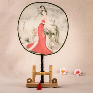 Traditional Chinese silk palace fan featuring classical beauty artwork and wooden stand for decor.