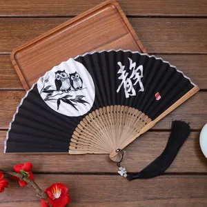 Chinese style folding fan with owl design, bamboo ribs and black tassel for gifts and photography.
