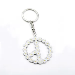 Porte-clés et bijou de sac en métal avec motif marguerite et symbole de paix.