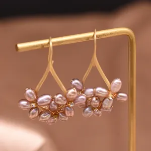 Freshwater purple pearl flower earrings detail close-up showing delicate petals and gold hooks.