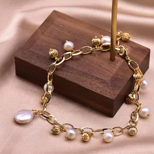 Gold-plated chain bracelet with freshwater pearls and vintage beads, elegant jewelry gift.