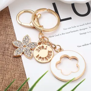 Portachiavi in lega d'oro con ciondolo a fiore a cinque petali in strass e ciondolo per borsa.