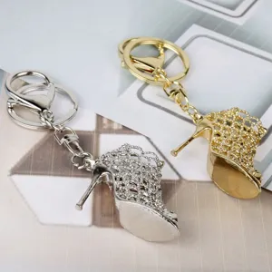 Metal high heel shoe keychain close up, sparkling rhinestone keyring accessory detailing.
