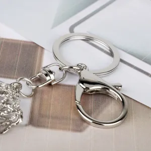 Close up view of silver metal keychain hardware detail, lobster clasp and split keyring charm.
