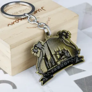 Metal keychain detail showing the Dubai camel and architecture design with bronze finish.