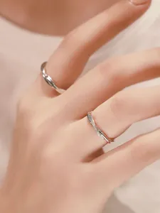 S925 sterling silver twisted couple rings with shimmering cubic zirconia, elegant open design.