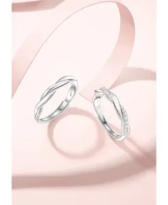 Close-up detail of the stunning twisted couple rings in S925 silver with sparkling zircon.