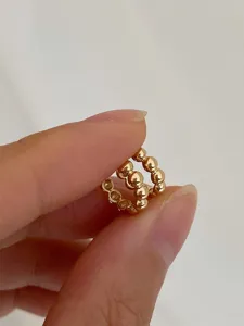 Detailed close-up view of elegant 18k gold plated beaded small hoop earrings for daily wear.