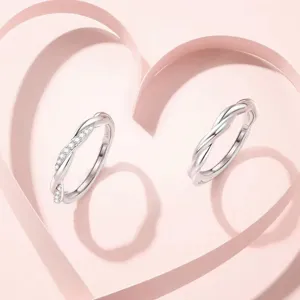 Details of S925 sterling silver couple twist rings with sparkling cubic zirconia stones.