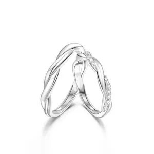 Detail view of interlocking silver couple rings with sparkling pavé cubic zirconia twist.
