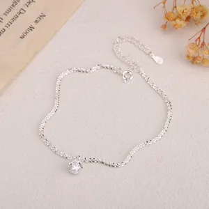 Detailed close-up of a sparkling silver bracelet with a single crystal stone and extension.