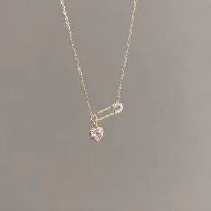 Detail shot of S925 silver safety pin necklace with pink heart cubic zirconia pendant sweet style.