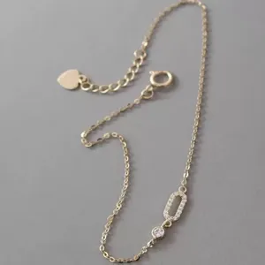 Detailed shot of S925 sterling silver zircon anklet, minimalist design with heart extension chain.