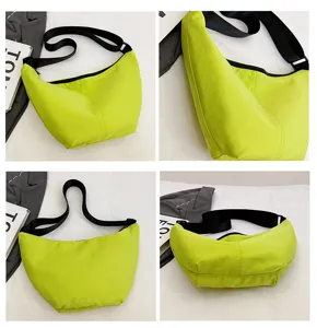 Vista detallada del bolso bandolera de nailon verde neon en forma de luna, estilo casual.
