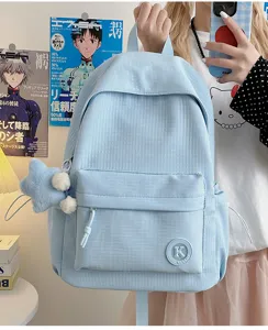 Light blue corduroy backpack for students, minimalist daily commute book bag with cute pendant.