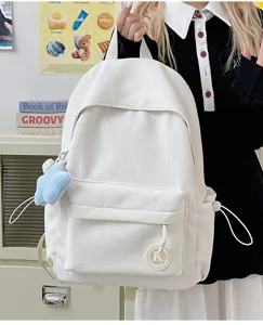 White corduroy backpack for women, lightweight daily school bag with laptop compartment and cute pendant.