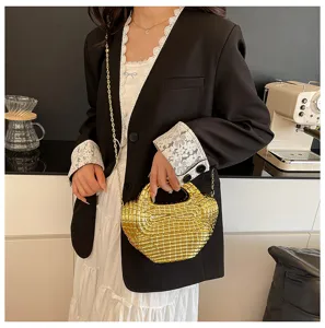 Detailed view of the stylish golden acrylic grid evening handbag with chain strap for women.