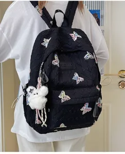 Detailaufnahme des schwarzen gesteppten Rucksacks mit bunten Schmetterlings-Stickereien.