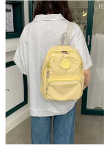 Sac à dos jaune en tissu oxford avec poches multiples, idéal pour l'école et vie quotidienne.