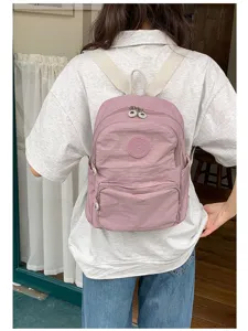Sac à dos décontracté en nylon rose pour femme, cartable scolaire multi-poches pratique.