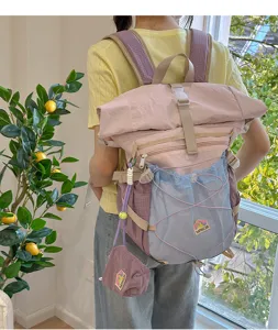 Detail view of the stylish large capacity roll-top student backpack with mesh front pocket.