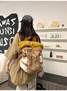 Casual college style student canvas backpack with large capacity roll top and multiple pockets.