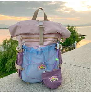 Detail shot of the fresh collegiate style roll-top student backpack in pink and blue.