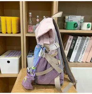 College style roll-top student backpack with multi-color patchwork, large capacity detail.