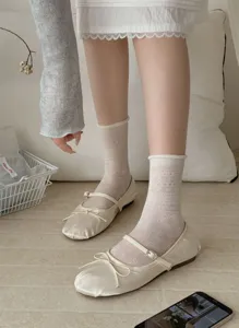 Detail view of breathable mesh hollow-out mid-tube socks featuring cute rolled edges.