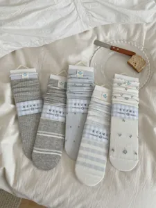 Cute women mid-tube slouch socks in light colors, ideal for sweet daily outfits styling.