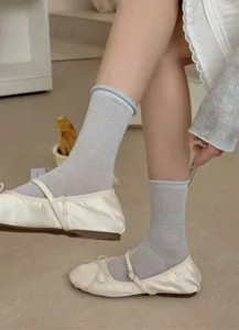 Close-up of sheer mesh breathable silk mid-calf socks featuring sweet rolled cuffs for summer.