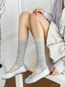 Grey stirrup socks paired with light blue ballet flats, stylish and trendy everyday wear.
