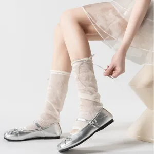 Chique ultra-dunne ballet-stijl beenwarmers met zoete lintjes, gecombineerd met zilveren schoenen.