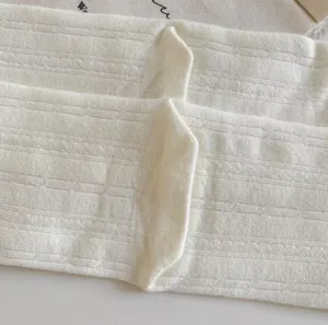White cotton mid tube socks detail shot, Japanese style ribbed knit texture, soft and comfortable.