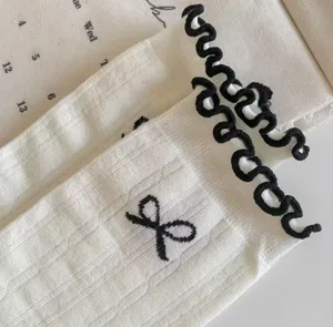 Japanese balletcore cotton mid-tube socks with cute bow embroidery and sweet ruffle edge.