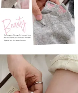 Detailed close-up of women's short cotton socks featuring cute pink bow embroidery design.