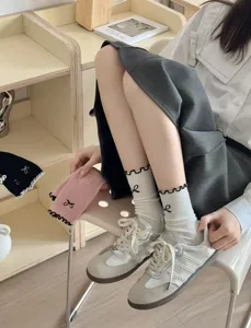 Japanese ballet style cotton mid-tube socks with cute ruffle lace and black bow details.