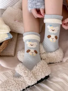 Close-up detail of cozy plush winter socks featuring cute cartoon dog patterns, soft texture.