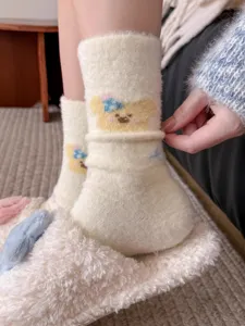 Detailed view of fluffy winter fleece slouch socks featuring a cute knit cartoon animal pattern.