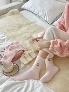 Cozy plush winter socks detail, thick warm fuzzy sleep socks with cute cartoon bear design.