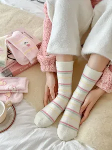 Cozy winter fuzzy socks for women, thick warm plush striped sleep socks for cold days.