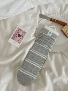 Grey striped slouchy socks detail view, cozy knitted mid-tube socks for autumn daily wear.