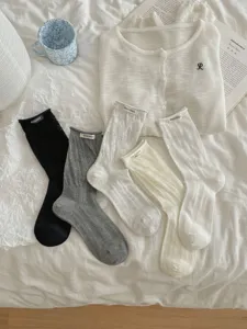 Korean style hollow knit mid-tube cotton socks with cute letter label for women.