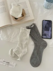 Detail view of spring summer women cotton hollow slouch socks with cute rolled edge design.