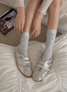 Women grey polka dot mid tube socks with trendy silver velcro sneakers for autumn daily wear style.