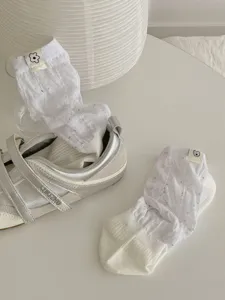 White cute mid-tube stack socks with colorful flecks and adorable cloth tags for women