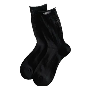 Chic black mid-calf socks for women, featuring cute hollow-out patterns and rolled cuffs.