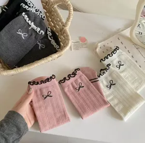 Ballet-core cotton mid-tube socks with cute ruffle edges and sweet bows for women.