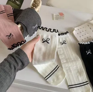 Sweet balletcore cotton mid tube socks with cute bow embroidery and ruffle cuffs for women.