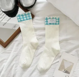 White mid-calf socks with blue plaid ruffles and cute embroidered tag for women daily wear.